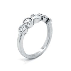 three stone diamond ring in white gold with diamonds on each side and four stones at the top