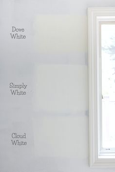 an empty room with white walls and paint samples on the wall next to a window