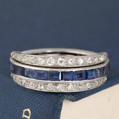 Another one of our personal faves, and a style which sells out almost immediately - the flip ring! Popular during the art deco era, they always feature a combination of gemstones and diamonds, with part of the ring "flipping" between 2 different sections to give the illusion of different bands being stacked together. With this band, you have the diamond band flipping between a blue sapphire section and a ruby section. Its literally 2 bands in one - you can't tell me that that's NOT fun and uniqi Art Deco Multi-stone Platinum Diamond Ring, Art Deco Diamond Ring With Gemstone, Art Deco Multi-stone Diamond Ring, Art Deco Platinum Multi-stone Rings, Art Deco Platinum Sapphire Ring With 17 Jewels, Platinum Multi-stone Art Deco Rings, Art Deco Multi-stone Platinum Rings, Art Deco Platinum Sapphire Ring, Art Deco Sapphire Ring With 17 Jewels