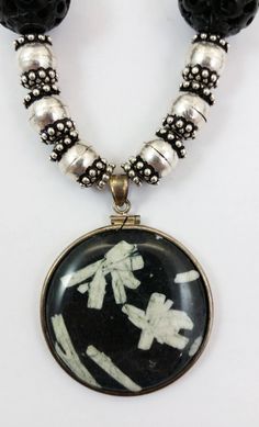 "The round, Sterling Silver wrapped Pendant in this necklace is made of Chinese Writing Stone. The carved round black beads in this necklace are an unknown material, possibly Onyx but maybe just glass or another black stone. The silver beads and clasp are Sterling Silver. Approximate Length (clasped): 11-1/2\" - (end to end): 25\" Black Bead Diameter: 18mm Silver Bead Diameter: 9mm Pendant Size: 40mm Diameter x 6mm Thick Approximate Total Weight: 5.2 Oz Rabbask Designs is a small business locate Black Amulet Necklaces With Polished Beads, Black Amulet Necklace With Polished Beads, Black Amulet Style Necklaces With Polished Beads, Black Bohemian Medallion Jewelry, Handmade Circular Black Necklaces, Handmade Black Circle Necklace, Handmade Circular Black Necklace, Handmade Black Circle Necklaces, Artisan Black Round Pendant Jewelry