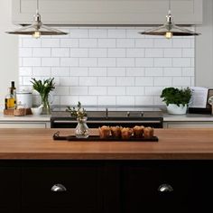 the kitchen counter is clean and ready to be used for cooking or baking, as well as potted plants