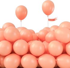 a bunch of pink balloons are in the shape of a pyramid with one balloon sticking out of it