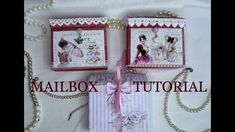 two small boxes with pearls and ribbon tied to them, sitting next to each other