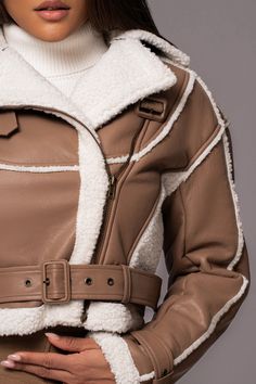 Upgrade your winter style with our Tan Faux Leather Sherpa Jacket. Made from high-quality faux leather, this biker style jacket features a contrasting sherpa design and long sleeves for added warmth. Complete with functional side pockets, front zipper closure, and is adorned with stylish belts at the neckline and hem. Pair with our Dakotah Maxi Dress for the full look. Materials: (Coating) 100% Polyurethane (Fabric) 100% PolyesterLength: (full) 20 in. (sleeve) 23 in.Product Origin: ImportedWashi Leather Sherpa Jacket, Stylish Belts, Winter Stil, Full Look, Sherpa Jacket, Biker Style, Winter Style, Front Zipper, Winter Fashion