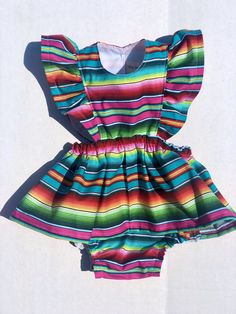 Perfect for all the summer 🥳 FIESTAS!! Handmade skirt romper. Made with cotton serape cotton fabric. These amazing pieces are made to order. Sizes 0-6 month up to 4T are made with attached bloomers and snaps at the saddle. Anything above a 4t (5t -7/8y) are the same style dress with no bloomers attached. If you have any questions on sizing please don't hesitate to message me. I will gladly help. Rainbow Summer Dress For Playtime, Rainbow Summer Dresses For Playtime, Summer Rainbow Playtime Dress, Fun Multicolor Sundress For Playtime, Playful Rainbow Cotton Dresses, Multicolor Summer Sundress For Playtime, Summer Beach Twirl Dress With Ruffles, Colorful Ruffled Dresses For Summer, Rainbow Cotton Dress For Playtime