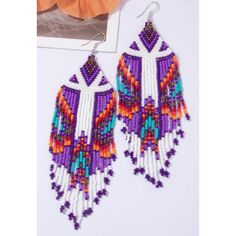 Beaded Tassel Drop Earrings Color: Purple & White Measurements: 5.5 Inches In Length 1.25 Inches In Width White Beaded Fringe Festival Jewelry, Festival White Beaded Fringe Jewelry, White Fringe Tassel Earrings For Festivals, White Dangle Tassel Earrings For Festivals, White Beaded Fringe Earrings For Festival, Adjustable Purple Bohemian Tassel Earrings, Bohemian White Beaded Fringe Earrings, White Bohemian Beaded Earrings With Dangling Beads, White Bohemian Beaded Dangling Earrings