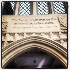 the front entrance to an old building with a plaque on it that says, the love which moves the sun and the other stars