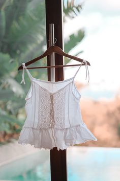 Beautiful Coachella white gauze tank top. A laid back bohemian style with cotton lace and frills. Front tie with cotton ties. Made of double cotton gauze cheese cloth. Size fits up to size 10. Preorder for 4 weeks. Shipped with DHL Express worldwide in 1 week duration. Casual Cotton Lace Top For Summer, Summer Cotton Lace Top, White Tie Back Camisole For Summer, Cotton Tank Top With Tie Straps For Beach, Cotton Lace Top For Summer, Summer White Camisole With Tie Straps, White Camisole With Tie Straps For Summer, White Tie-strap Camisole For Summer, Cotton Lace Top For Summer Vacation