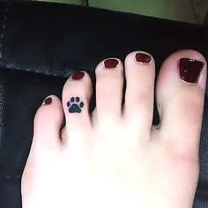 a person's foot with a paw tattoo on it