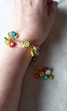 a person wearing a bracelet with beads on it