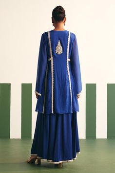 Cobalt blue peplum anarkali with floral embroidered yoke and sequins, nalki, cutdana work. Paired with a sharara and dual tone dupatta.
Components: 3
Pattern: Embroidery
Type Of Work: Sequins, Nalki, Cutdana, Floral
Neckline: V Neck
Sleeve Type: Bell Sleeves
Fabric: Anarkali: Organza, Sharara: Cotton Satin
Color: Blue
Other Details: 
Embroidered hem sharara
Occasion: Sangeet - Aza Fashions Blue Designer Dress For Transitional Season, Blue Chikankari Embroidered Dress With Traditional Drape, Blue Chikankari Embroidery Designer Dress, Floor-length Blue Sharara With Chikankari Embroidery, Blue Floor-length Sharara With Chikankari Embroidery, Blue Straight Kurta Set For Reception, Blue Transitional Dress For Reception, Designer Blue Chanderi Dress, Blue Chikankari Embroidery Palazzo Set For Reception