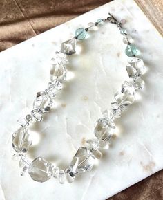 Quartz crystal is a clear natural stone with inclusions and variations in shape. Each stone has a unique shape. A few faceted aqua stones near the clasp add a fun hint of color. This 18inch necklace has a large sterling silver toggle that is easy to clasp. It gorgeous with an evening gown on a special occasion, but also fun enough to add class to a more casual outfit. Aqua Stone, Quartz Crystal Necklace, Clear Quartz Crystal, Bead Jewellery, Crystal Quartz, Quartz Necklace, Fort Worth, Clear Crystal, Evening Gown