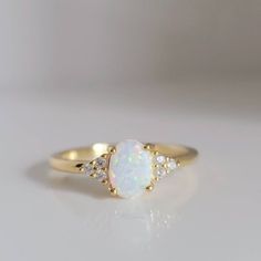 Exquisite And Distinctive White Rainbow Opal Ring Crafted In 14k Gold Over 925 Sterling Silver. Its Iridescent Play Of Colors Catches The Light With Every Movement, Making It A Truly Enchanting Accessory. The Ring's Delicate Design Showcases The Opal's Natural Beauty, While The 14k Gold Adds A Touch Of Timeless Elegance. Perfect For Special Occasions Or Everyday Wear, This Ring Is A Unique Statement Piece That Speaks To The Wearer's Individuality And Refined Taste. Whether Given As A Gift Or Wor Antique Opal Ring Silver, Gemstone Promise Rings, Antique Opal Ring, Opal Wedding Ring Set, White Opal Engagement Ring, Opal Stone Ring, Opal Wedding Ring, Pretty Engagement Rings, Pretty Jewelry Necklaces