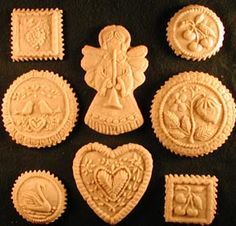 some cookies that are shaped like angels and hearts