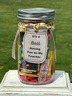 a jar filled with lots of different colored candies