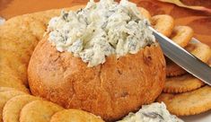 a bread bowl filled with cream cheese and crackers