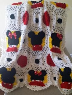 a crocheted blanket with mickey mouses on it