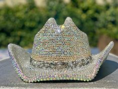 I am now offering custom bedazzled cowboy hats that sparkle beyond belief due to the high quality glass crystal rhinestones I use. I can make yours using a hat of your choice if you prefer to supply your own, or from a selection of 5 colors I have sourced that are good quality faux suede: White, ivory, Tan, Pink or Black.  They come in two sizes S/M or L/XL. These hats are made to last! They require almost 30 hours of meticulous labour. The brims are covered in rhinestones using permanent adhesive both upper and under sides for extra spectacular sparkle! I can source any color rhinestones, so feel free to message me about color choices or options. If you prefer a lower cost option that weighs a little less, I can use resin rhinestones instead, but I suggest the glass crystals for their sup Bejeweled Cowboy Hat, Western Bling Hat For Rodeo, Western Hats With Bling For Rodeo, Western Style Bling Hats For Rodeo, Western Style Hat With Bling And Curved Brim, Western Wide Brim Hat With Bling, Silver Hat With Rhinestones For Rodeo, Silver Rhinestone Hat For Rodeo, Western Silver Hat With Rhinestones