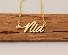 "Personalized Name Necklace, Engraved Necklaces for Women, Name Plate Necklace Wedding Gift for Nia This necklace is made of Stainless Steel Available color: Gold, Silver and Rose Gold Chain Length: 14\"16\"18\"20\"22\" inches Processing Time: 2-10 business days Standard Shipping: 10-15 business days to USA. 15-30 business days to other countries. Expedited Shipping: 5-8 business days to USA. 5-10 business days to others. Please do not hesitate to contact us with any concerns." Gold Nameplate Jewelry For Wedding Gift, Gold Nameplate Necklace For Wedding Gift, Elegant Gold Name Necklace For Wedding Gift, Laser Engraved Necklaces For Wedding And Mother's Day, Elegant Nameplate Necklace With Laser Engraving, Engraved Name Necklace For Wedding, Engraved Gold Necklace For Bridesmaid Gift, Elegant Laser Engraved Nameplate Necklace, Gold Engraved Necklace For Bridesmaid Gift