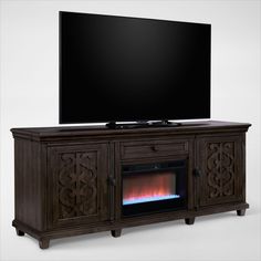 an entertainment center with a fireplace and flat screen tv mounted on it's sides