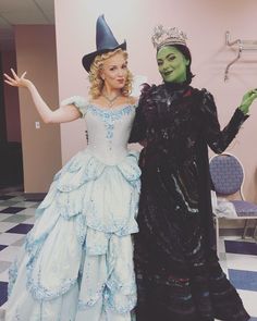 two people dressed up in costumes standing next to each other