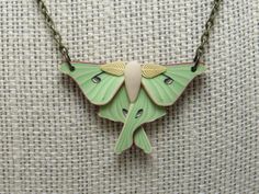 This stunning pendant necklace features a luna moth in shimmery pale green with beige and bronze accents. I created the wings with a process called caning, where different colors of clay are pieced together, reduced down to size, and sliced.  The pendant measures about 1 1/2 inches wide and is finished with an 18 or 20" antique brass chain. More moth items: https://www.etsy.com/shop/PasticheAccessories?ref=seller-platform-mcnav&search_query=Moth Green Butterfly Nature-inspired Jewelry, Nature-inspired Green Butterfly Jewelry, Green Butterfly Pendant Necklace, Handmade Green Butterfly Necklace, Green Bohemian Butterfly Jewelry, Bohemian Green Butterfly Jewelry, Polymer Clay Realistic, Clay Realistic, Beaded Necklace Green