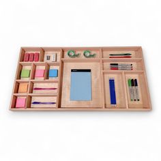 a wooden desk organizer with pens, pencils and markers