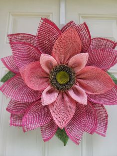 a pink flower is hanging on the front door