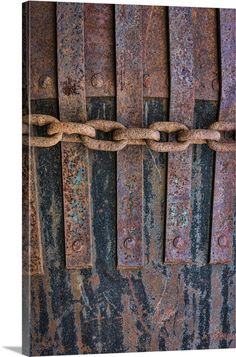 an old rusted metal chain is hanging on the wall