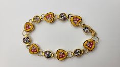 "This is a beautiful vintage 1960s micro mosaic bracelet. ATTRIBUTES  - Made in Italy - Tiny pieces of glass are used as tiles to create a beautiful pattern - Half of the links are shaped like hearts, the other half are round, and each link has tiny flowers in them - Set in goldtone - Some wear to the goldtone consistent with the age of the piece - Hook clasp MEASUREMENTS - The bracelet is about 6\" long, so it will only fit a *small wrist* such as a child or small adult unless you use an extend Mosaic Heart, 1960 Jewelry, Red Blue White, Micro Mosaic, Hook Clasp, Tiny Flowers, Heart Bracelet, Vintage 1960s, Chain Link Bracelet