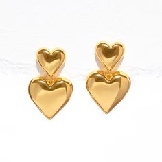 Give double the love with the Heartfelt Dangle Earrings! These bold beauties feature not one, but two hearts, adding a playful touch to your style. Whether you're off for a casual coffee date or a night out with friends, these earrings are your perfect match for a look that's as cute and fun as you are! Trendy Earrings For Anniversary And Mother's Day, Trendy Heart Charm Earrings For Mother's Day, Trendy Heart-shaped Earrings For Mother's Day, Trendy Heart Charm Earrings For Anniversary, Trendy Heart-shaped Drop Earrings For Anniversary, Trendy Heart Earrings For Mother's Day, Trendy Double Heart Jewelry For Valentine's Day, Trendy Heart Drop Earrings For Anniversary, Trendy Anniversary Heart Drop Earrings