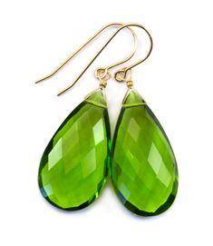 The great fun color of simulated peridot green earrings. Lots of sparkle and the color is richer than the photos. The substantial high quality ear wires are Sterling Silver or 14k Solid Gold or 14k Gold Filled - you choose. The gemstone size is a super large 15x28mm, earrings hang 1.7 inches. The mannequin shows the relative size and how they will hang. Please check out my store for more gemstone earrings, bracelets and necklaces. Remember - Free Shipping! Classic Green Pear Shaped Earrings, Classic Green Pear-shaped Earrings, Green Pear-shaped Earrings For May Birthstone, Green Faceted Teardrop Earrings, Green Drop Teardrop Earrings For Formal, Green Teardrop Earrings For Formal Occasions, Formal Green Teardrop Drop Earrings, Classic Green Drop Jewelry, Green Pear-shaped May Birthstone Earrings