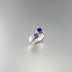 Ring square blue Lapis Lazuli and Sterling silver. Unique gift for her or him, girlfriend, wife, friend, September and December birthstone, 9 year anniversary. Geometrical design and the blue of Lapis Lazuli make this a very special ring. The stones a accurately designed for this special effect. This beautiful ring is worked with the technique of inlay, which means the stone is worked seamlessly into the Sterling silver. All our stones are natural stones and our jewelry is handmade, slight diffe Modernist Blue Gemstone Jewelry, Modern Sapphire Ring With Polished Finish, Modern Sapphire Promise Ring, Blue Modernist Jewelry With Polished Finish, Modernist Blue Jewelry With Polished Finish, Modern Rectangular Birthstone Jewelry, Rectangular Sapphire Promise Ring In Sterling Silver, Modern Rectangular Jewelry For Anniversary, Modern Blue Gemstone Rings