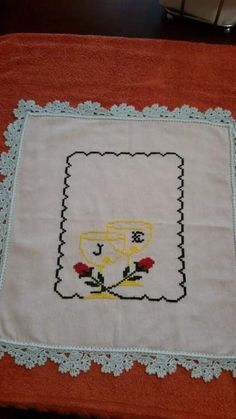 a cross - stitched table runner with an embroidered design on the edges and border