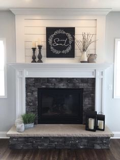 a fireplace with a mantle and candles on it