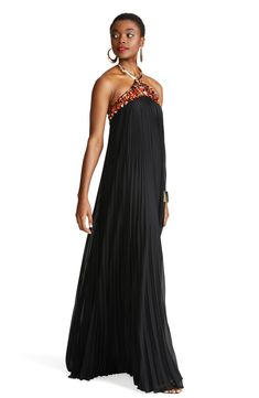 An abundance of embellishments at the top lend touchable texture and shine to a glamorous floor-length gown in flowing pleated chiffon. 64" length (size 8) Clasps at neck; hidden back-zip closure Halter neck Sleeveless, with cutaway shoulders Lined 100% polyester Dry clean Imported Glamorous Floor-length Pleated Evening Dress, Evening Chiffon Gown With Pleated Bodice, Pleated Floor-length Evening Dress, Silk Pleated Floor-length Gown, Silk Floor-length Pleated Gown, Silk Chiffon Floor-length Evening Maxi Dress, Embellished Chiffon Maxi Dress For Formal Occasions, Formal Embellished Chiffon Maxi Dress, Glamorous Floor-length Chiffon Gown