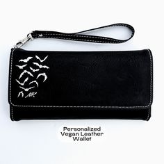 "This listing is for one Goth Wallet Bat Wallet Personalized Cute Wallet Vegan Leather Wristlet Wallet Goth Accessories Custom Gothic Gift Halloween Wristlet . PRODUCT DETAILS: ❧ Size: 7 1/2\" x 4\" ❧ Color: Black with Silver engraving (also available in purple faux leather with black engraving)  ❧ 12 card slots ❧ ID slot ❧ Zipper compartment for change ❧ Larger compartment for bills ❧ RFID protection ❧Detachable wrist strap and a snap closure  HOW TO ORDER: ❧ Please select your color (Black or Black Clutch Wristlet For Gift, Black Wristlet With Card Slots For Gift, Black Clutch Wallets As Gift, Goth Wallet, Cute Wallet, Goth Accessories, Gothic Gifts, Cute Wallets, Silver Engraving