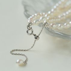 Product Information: Plating: White Gold Material: Freshwater Pearls (5-5.5mm) Size: Necklace Length 37-44 cm Weight: 28.5g Description: Elevate your style with our "Pulldown Double-Layer Beaded Pearl Necklace." This exquisite necklace features high-quality freshwater pearls, each measuring 5-5.5mm, and is elegantly plated with white gold. With an adjustable necklace length of 37-44 cm, it provides versatility in styling and ensures a perfect fit for any occasion. The double-layer design with de Elegant Multi-strand Pearl Necklace With Charm, Elegant Double Strand Pearl Necklace With Charm, Multi-strand Pearl White Necklace With Pearl Pendant, Double Strand Pearl Drop Necklace, Classic Pearl White Multi-strand Necklaces, Classic Multi-strand Pearl White Necklaces, Elegant Double Strand Pearl Chain Necklace, Classic Multi-strand Pearl White Necklace, Elegant Double Strand Pearl Necklace