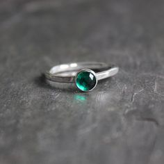 Emerald is the birthstone for May and the gemstone to give for the 20th & 55th wedding anniversaries. And, it is thought to promote friendship, peace, and domestic bliss by enabling the wearer to both give and receive unconditional love. Here are the details: This ring is made with a 6mm rose cut emerald green cabochon bezel set on a sturdy sterling silver band handmade in your size. It can be worn with other stackable rings, or by itself.Please select your ring size. Sizes are US based. May Birthstone Stackable Round Stone Jewelry, Stackable May Birthstone Jewelry With Round Stones, Stackable Emerald Jewelry For Anniversary, Stackable Round Stone Jewelry For May Birthstone, Stackable Round May Birthstone Jewelry, Emerald Round Band Ring For May Birthstone Anniversary, May Birthstone Jewelry With Tension Setting For Anniversary, Classic Crystal Ring With Birthstone For Promise, Emerald Solitaire Birthstone Promise Ring