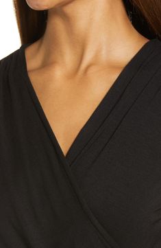 A faux-wrap front flatters on this soft and versatile jersey top cinched with a saucy tie at the hip. 23 1/2" length Surplice V-neck Short sleeves 95% rayon, 5% spandex Machine wash, dry flat Imported Women's Clothing V-neck Wrap Top With Tie Waist For Work, Chic Tops With Tie Waist And Surplice Neckline, Solid Color V-neck Faux Wrap Top, V-neck Top With Tie Waist For Work, V-neck Wrap Top For Loungewear, Solid V-neck Faux Wrap Top, Faux Wrap V-neck Top, Versatile V-neck Ruched Tops, V-neck Faux Wrap Top For Layering