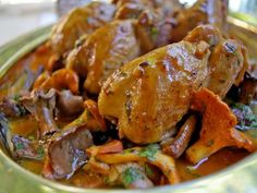 a bowl filled with meat and vegetables on top of a table