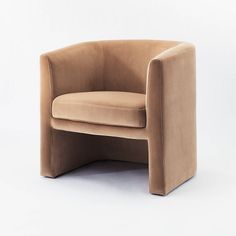 a beige chair sitting on top of a white floor