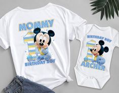 a mickey mouse birthday shirt and onesuit with the number one on it's chest