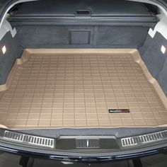 the trunk area of a car with its cargo compartment open and floor mats folded down