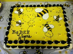 a birthday cake with bees on it sitting on a table