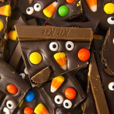 many pieces of chocolate with candy eyes and candies