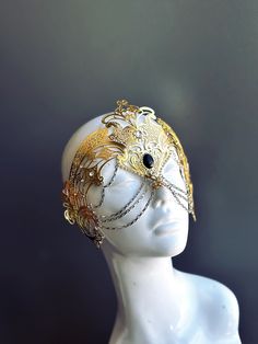 Step into the realm of goddesses with our women's masquerade mask in gold. Rhinestones delicately embellish the mask, adding a touch of sparkle. Silver chains gracefully adorn the mask, creating an enchanting movement. Capture attention at any masquerade party, ball, or themed event!


Age Group/Gender - Adult/Women

Size/Type - One size fits all adults

Mask Color - Gold

Mask Material - Laser Cut Metal

Special Features - Chains and rhinestones Gold Fantasy Style Masquerade Mask For Party, Gold Fantasy Masquerade Mask For Party, Gold Metal Jewelry For Costume Party, Gold Jewelry For Costume Party, Gold Fantasy Festival Masks And Prosthetics, Elegant Gold Mask For Masquerade, Adjustable Full Face Mask For Masquerade, Gold Venetian Eye Mask For Masquerade, Elegant Gold Masks And Prosthetics For Masquerade