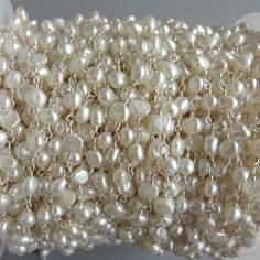 a bunch of white pearls sitting on top of a table