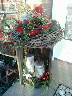 a wreath on top of a table with candles