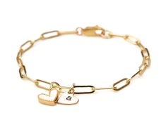 Experience the poetic harmony of love with our Personalized Love Duet Bracelet. Crafted from our delicate Gold-Plated paperclip chain, featuring 3 X 9mm links, this bracelet hosts two hearts—an enchanting fusion of one heart in white enamel and Gold-Plate and the other in 14 karat gold filled allure. Measuring about 1/4"x1/4" each, these hearts, with their distinct shapes, engage in a graceful choreography along the sophisticated paperclip chain. Customize the golden heart with a single initial, White Gold Paperclip Chain Bracelet As Gift, White Gold Paperclip Chain Bracelet Gift, Paperclip Chain Jewelry For Mother's Day Anniversary, Personalized Adjustable Paperclip Bracelet, Everyday Paperclip Chain Jewelry For Valentine's Day, Modern Cable Chain Charm Bracelet As Gift, Valentine's Day Jewelry With Paperclip Chain, White Rectangular Links Jewelry For Gift, White Rectangular Link Jewelry Gift